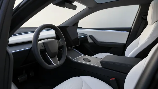The interior of a Tesla Model Y with a black key card on the center console and the screen off (AI-generated image)
